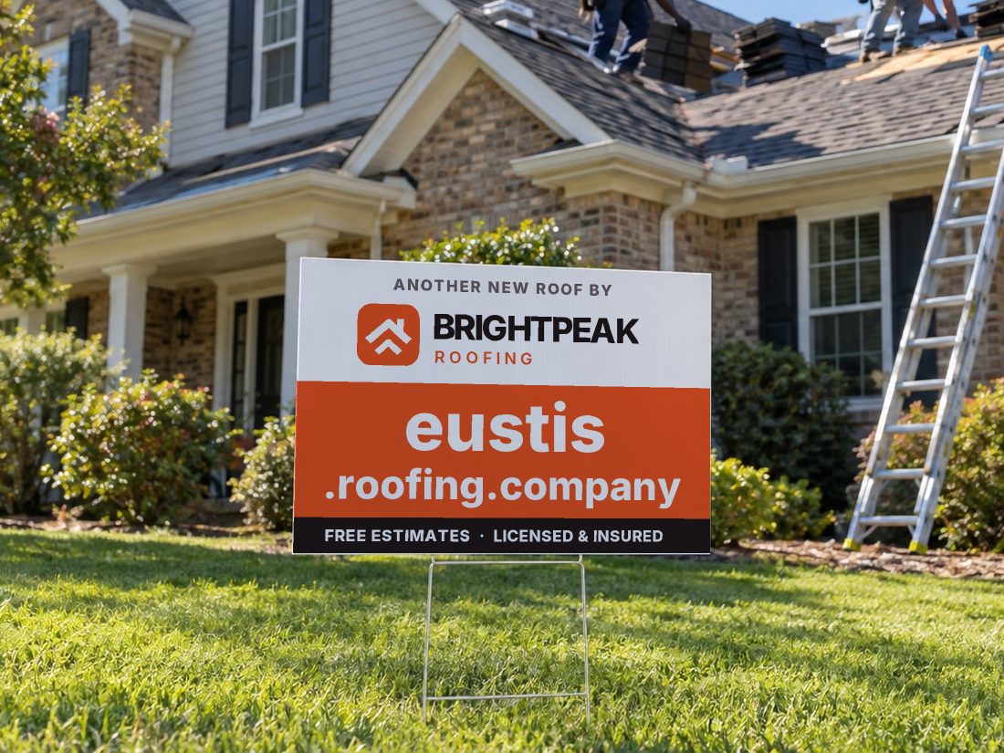 eustis.roofing.company on a yard sign in front of a house getting a new roof